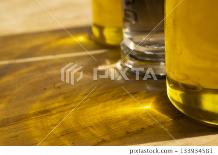 olive oil bottle on wooden cutting board in modern kitchen interior olive oil bottle on wooden cutting board in modern kitchen interior 133934581