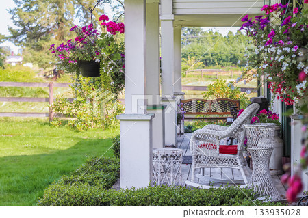 Summer terrace, table and chairs with flowers in a countryside. Summer terrace, table and chairs with flowers in a countryside. 133935028