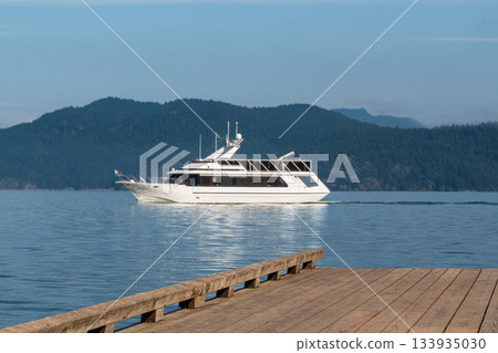 View of lake and big white yacht with mountains in the background View of lake and big white yacht with mountains in the background 133935030