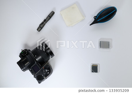 Aerial view of camera and maintenance supplies arranged on a white background Aerial view of camera and maintenance supplies arranged on a white background 133935209