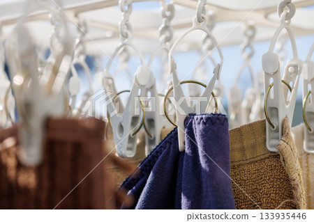 Hanging out laundry on a sunny day, laundry and clothespins 133935446