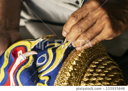 close up of artist painting lakhon khol traditional mask in cambodia close up of artist painting lakhon khol traditional mask in cambodia 133935646