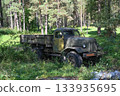 An old abandoned Soviet truck stands in a forest 133935695