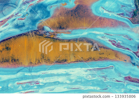 Abstract nature background. Top view of the bottom of a dry estuary. Colorful ground texture Abstract nature background. Top view of the bottom of a dry estuary. Colorful ground texture 133935806