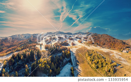 View from above of mountain landscape in early winter, snowy slope. Ski resort Station Les Monts d'Olmes, France View from above of mountain landscape in early winter, snowy slope. Ski resort Station Les Monts d'Olmes, France 133935954