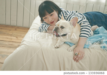 狗和女人躺在床上 133936068