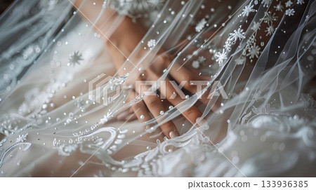 close-up shot of the bride's hand reaching out to touch her veil, adorned with delicate silver stars and lace, symbolizing its significance in wedding ceremony decor close-up shot of the bride's hand reaching out to touch her veil, adorned with delicate silver stars and lace, symbolizing its significance in wedding ceremony decor 133936385