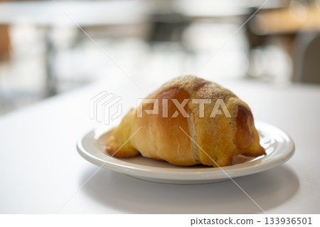 Salted bread with sweet sauce on the top, served on plate on the table 133936501