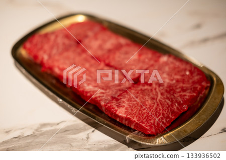 Raw Sliced Hanwoo Beef, marbled Korean Style Meat prepared on the golden plate Raw Sliced Hanwoo Beef, marbled Korean Style Meat prepared on the golden plate 133936502
