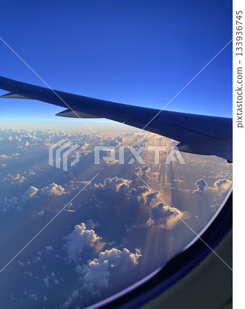 Beautiful dawn seen from an airplane window Beautiful dawn seen from an airplane window 133936745