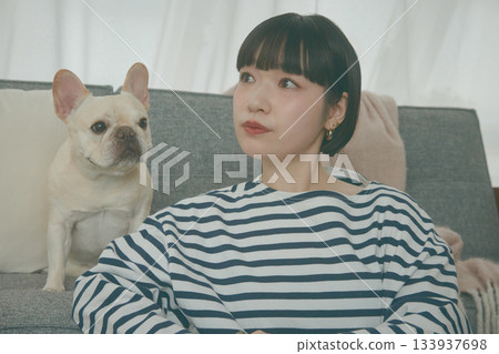 Dog and woman relaxing on sofa 133937698