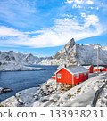 Traditional Norwegian red wooden houses on the shore of  Reinefjorden in Hamnoy village . 133938231