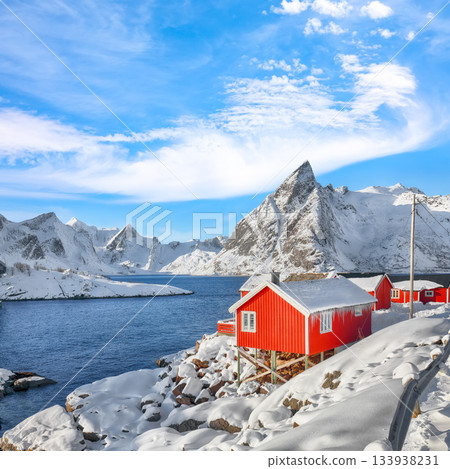 Traditional Norwegian red wooden houses on the shore of  Reinefjorden in Hamnoy village . 133938231