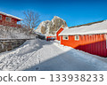 Traditional Norwegian red wooden houses on the shore of  Reinefjorden in Hamnoy village . 133938233