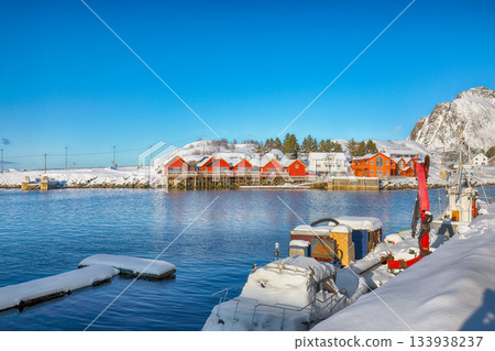 Winter view on Hamnoy village with port and Festhaeltinden mountain on background. 133938237