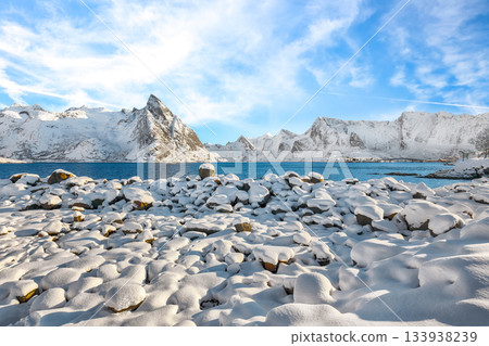 Shore of  Reinefjorden on Toppoya island with Olstinden peak  on background. 133938239