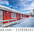 Traditional Norwegian red wooden houses on the shore of  Reinefjorden in Hamnoy village . 133938241