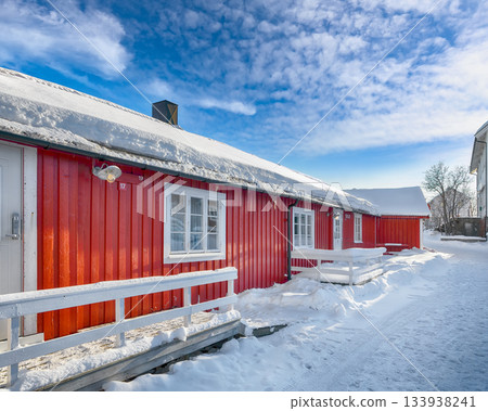 Traditional Norwegian red wooden houses on the shore of  Reinefjorden in Hamnoy village . 133938241