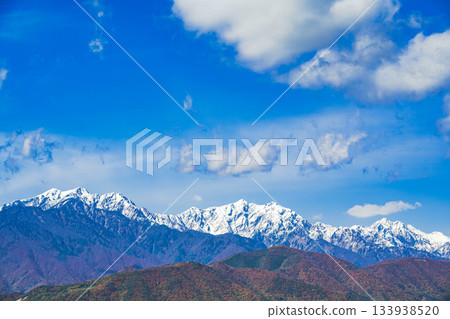 The Hakuba mountains, covered in three layers of autumn foliage after snow, seen from Omachi City The Hakuba mountains, covered in three layers of autumn foliage after snow, seen from Omachi City 133938520