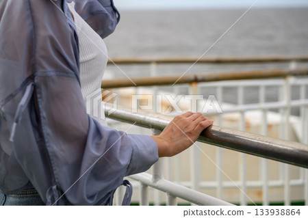Woman gazing at the sea from a boat 133938864
