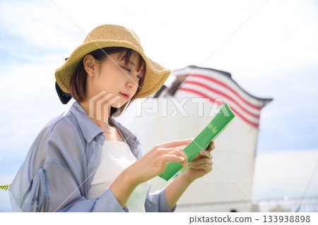Travel woman guidebook on board Travel woman guidebook on board 133938898