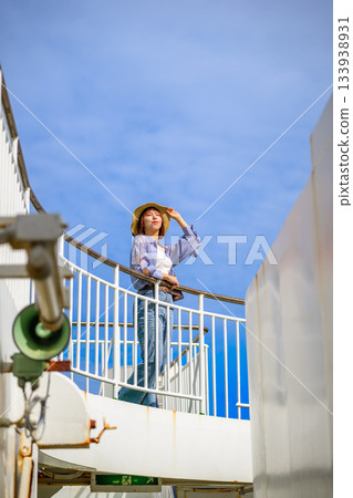 A woman avoiding the sun on a boat 133938931