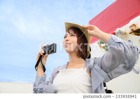 Woman taking a photo on a ferry 133938941