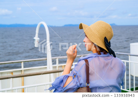Woman looking out at the sea on a ferry Woman looking out at the sea on a ferry 133938943