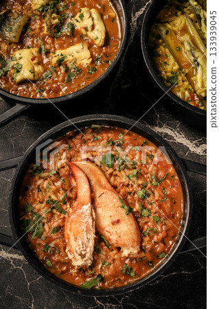 Portuguese traditional food fish soup and seafood risotto meal on restaurant table in lisbon Portuguese traditional food fish soup and seafood risotto meal on restaurant table in lisbon 133939045