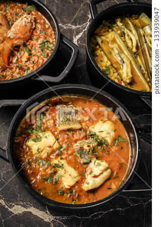 Portuguese traditional food fish soup and seafood risotto meal on restaurant table in lisbon Portuguese traditional food fish soup and seafood risotto meal on restaurant table in lisbon 133939047
