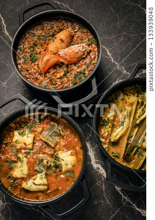 Portuguese traditional food fish soup and seafood risotto meal on restaurant table in lisbon Portuguese traditional food fish soup and seafood risotto meal on restaurant table in lisbon 133939048