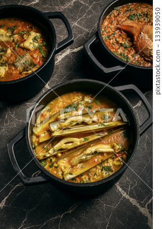Portuguese traditional food fish soup and seafood risotto meal on restaurant table in lisbon Portuguese traditional food fish soup and seafood risotto meal on restaurant table in lisbon 133939050