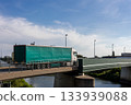 Scenic view modern semi trailer truck drive bridge over Elbe river industrial landscape German Magdeburg  harbor port background.  Global trade logistics shipment goods distribution delivery 133939088