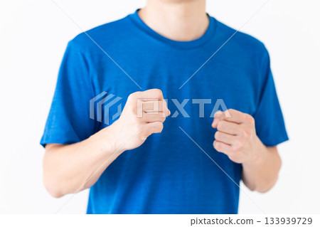 A middle-aged man in a T-shirt taking a martial arts stance A middle-aged man in a T-shirt taking a martial arts stance 133939729