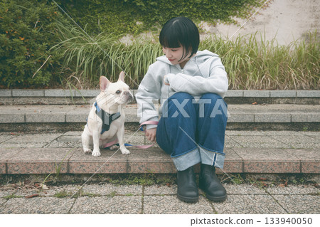 A woman walking a dog A woman walking a dog 133940050