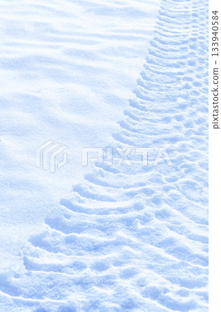 Tractor clear trail tracks in snow blue tone sunny day 133940584