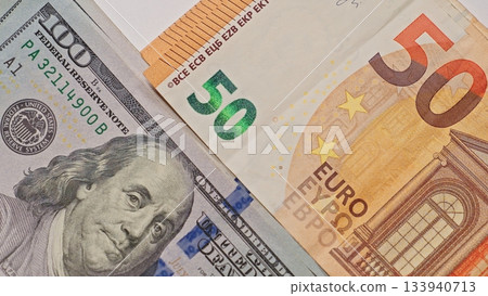 Closeup of a US hundred dollar bill and euro fifty banknote overlapping, symbolizing global finance, currency exchange, money transfer, and international economic relations. Closeup of a US hundred dollar bill and euro fifty banknote overlapping, symbolizing global finance, currency exchange, money transfer, and international economic relations. 133940713