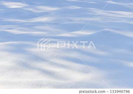 Fresh sparkling wavy snow snowdrifts close-up, perfect as a winter season background or texture 133940796