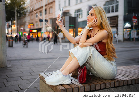 Young woman taking selfie with smartphone in Vienna city Young woman taking selfie with smartphone in Vienna city 133940834