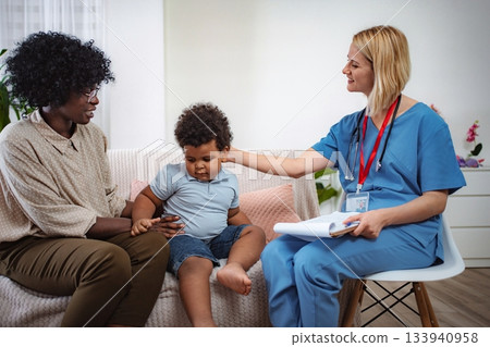 Caring doctor listening to family concerns Caring doctor listening to family concerns 133940958