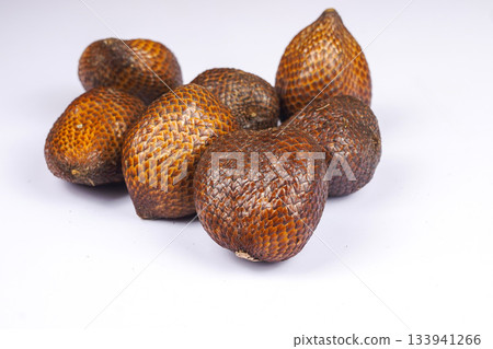 Fresh salak fruit or snake fruit with textured brown skin on white background Fresh salak fruit or snake fruit with textured brown skin on white background 133941266