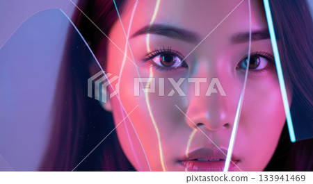 Asian woman with long dark hair, illuminated by vibrant neon lights, gazes intensely through translucent geometric shapes, embodying modern beauty and artistic expression 133941469