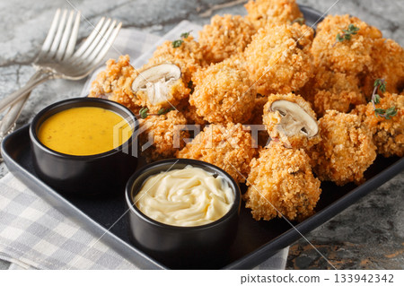 Crispy Garlic Breaded Mushrooms close-up in a plate. Horizontal Crispy Garlic Breaded Mushrooms close-up in a plate. Horizontal 133942342