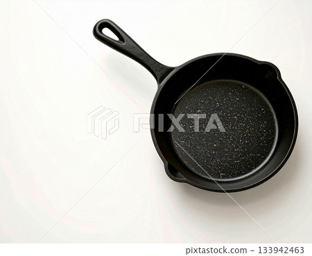 Kitchen atmosphere. Cast iron pan. Kitchenware on white background. Top view. Kitchen atmosphere. Cast iron pan. Kitchenware on white background. Top view. 133942463