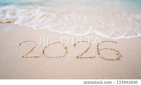 number 2026  write on sandy beach for new year, with ripple sea wave crashing with white bubble, 2026 New Year celebration concept 133942690