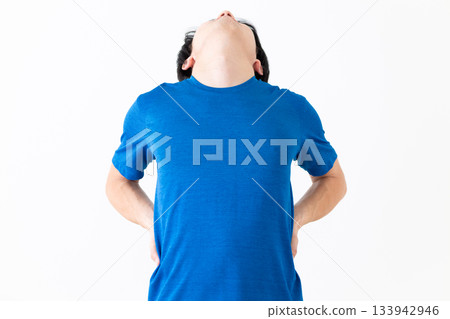 Middle-aged man in a T-shirt doing stretching exercises 133942946