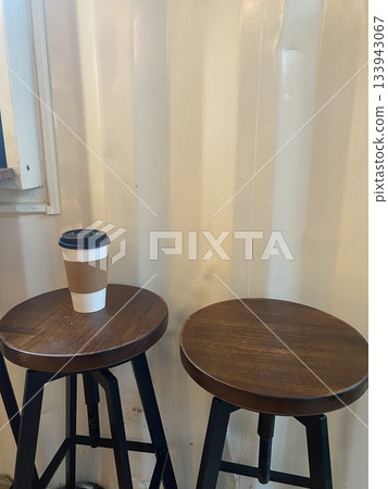 coffee cup on wooden stool in minimalist cafe shop 133943067