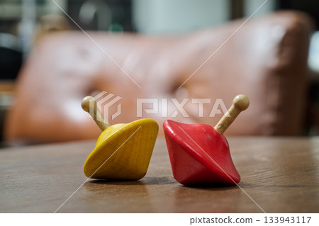 wooden spinning tops on a living room coffee table 133943117