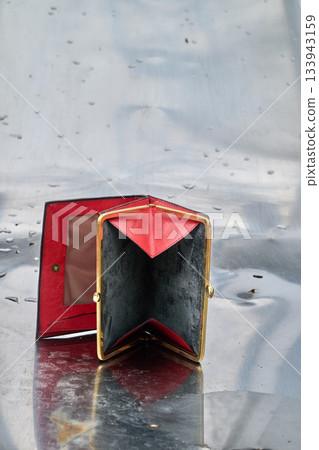 Wallet open against a shiny metal background Wallet open against a shiny metal background 133943159