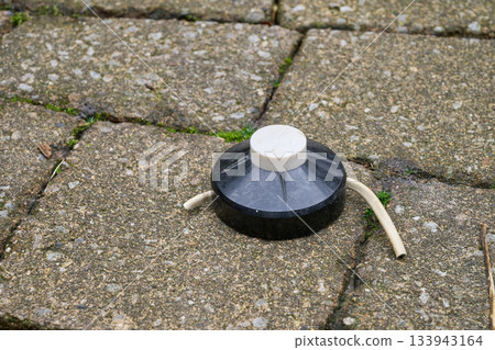 floor switch button on paved ground 133943164